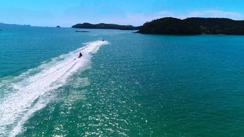 Jet skis chasing the sun in near Paihia, Bay of Islands